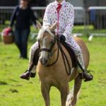 Perth Show…05.08.16
7 year old Daisy Fleming keeping her show outfit clean by wearing a ‘Onesie’ with her pony ‘Mini’
Picture by Graeme Hart.
Copyright Perthshire Picture Agency
Tel: 01738 623350  Mobile: 07990 594431